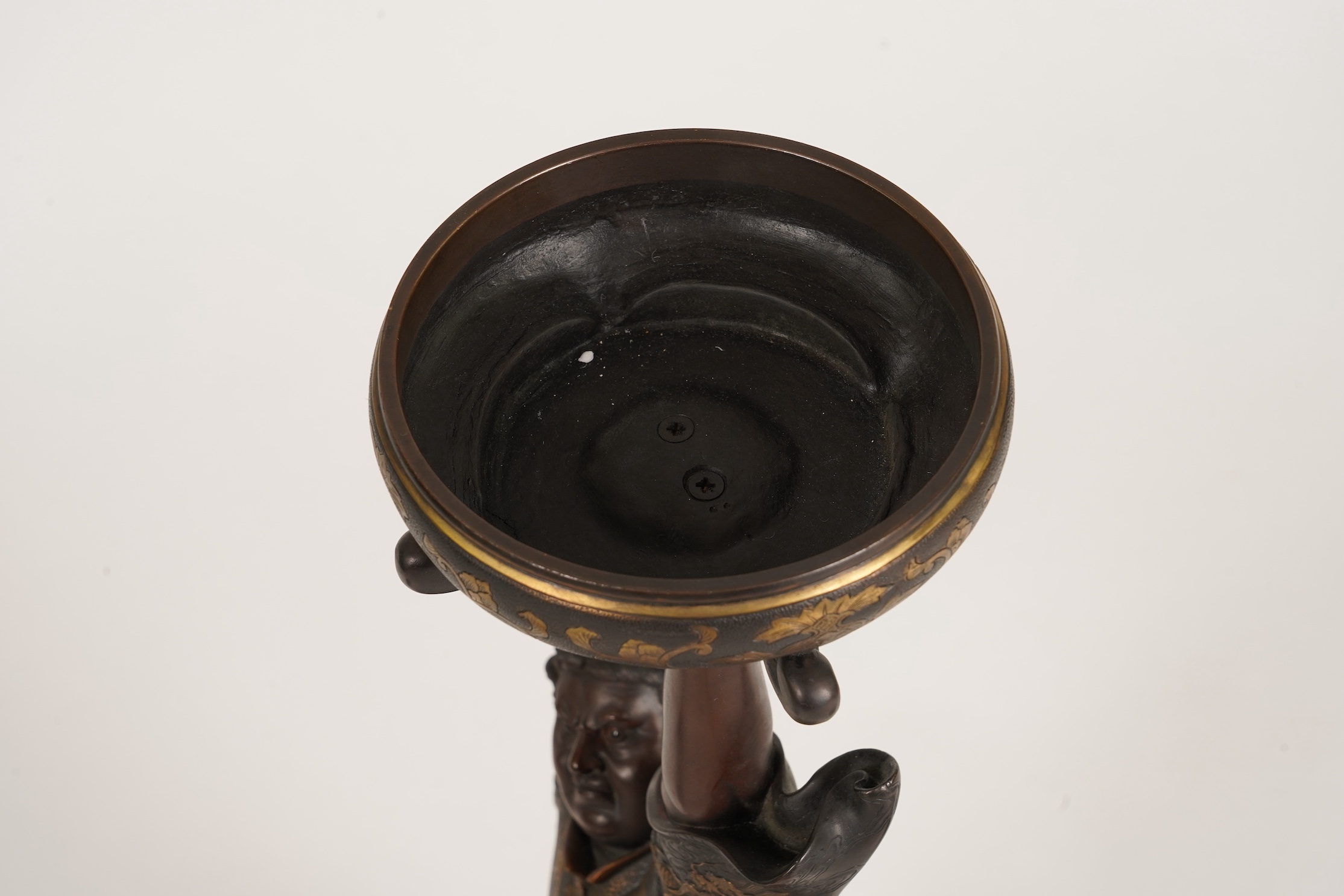 A large Japanese Miyao style parcel gilt bronze figure holding a koro aloft, 20th century